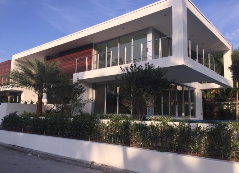 Modern residential home with glass railings and impact windows
