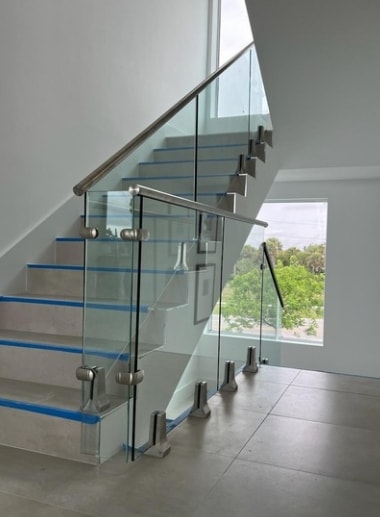 Interior glass railing system on modern staircase