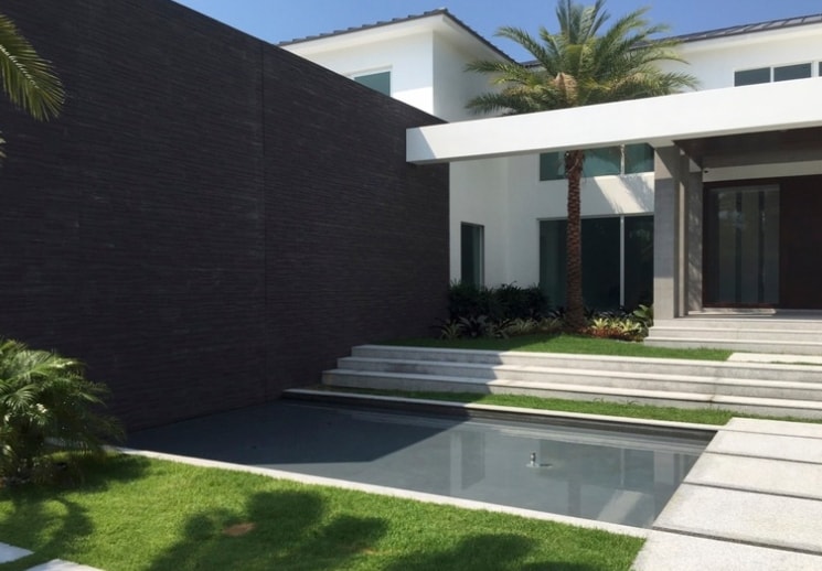 Luxury waterfront residence with cable railings and impact glass